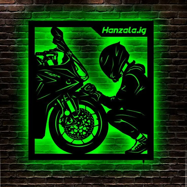 Motorcycle rider lit green from behind